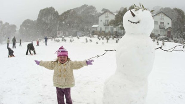 Little trouper...Holly Foard-Whitelaw, 3, delights in the snow at Thredbo yesterday as NSW ski resorts experienced their first snow in April for 13 years.