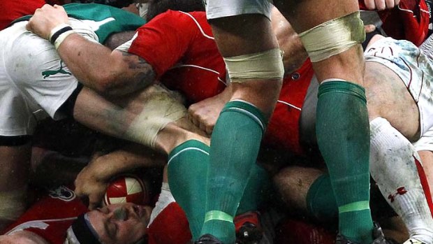 Leigh Halfpenny of Wales holds the ball at the bottom of the ruck.