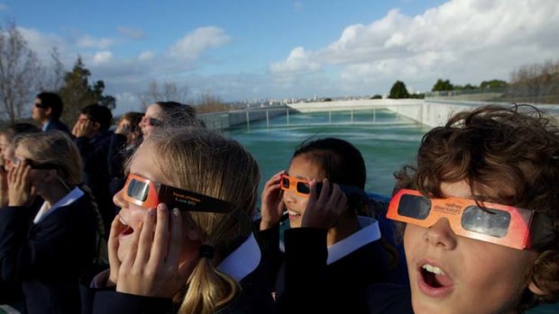 Once in a lifetime ... primary school students from Redlands Junior School watched the astronomical event through solar glasses.
