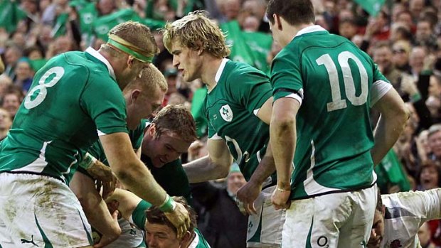 Ireland centre Brian O'Driscoll is congratulated by his teammates after scoring a try.