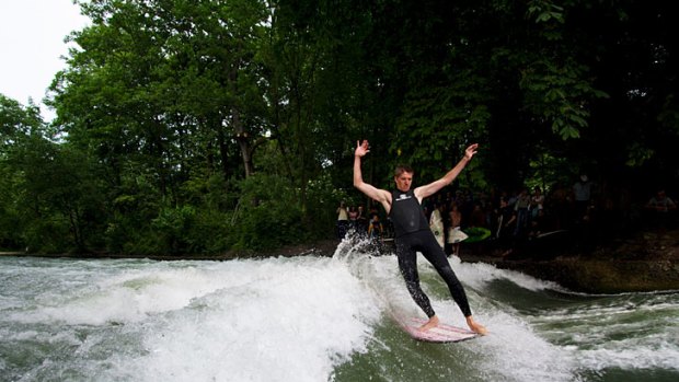 Toes on the nose ... a surfer rides Munich’s Eisbach standing wave.
