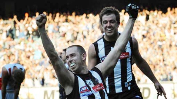 Collingwood captain Nick Maxwell and Steele Sidebottom celebrate as the final siren sounds.