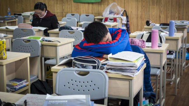 A student sleeps between classes at the prestigious Shanghai High School.