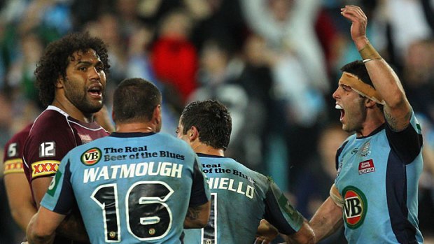 Michael Ennis lets Sam Thaiday know of his knock on.