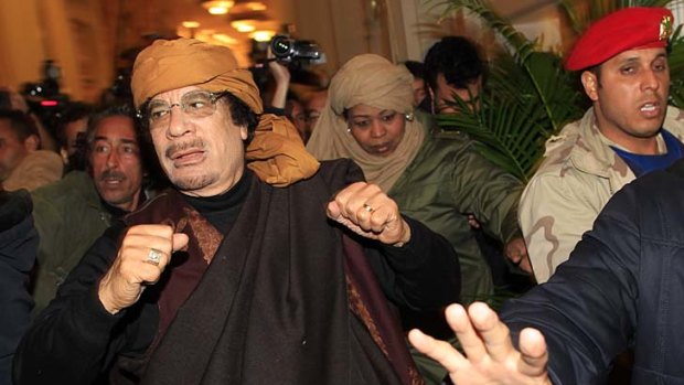 Muammar Gaddafi arrives to give television interviews at a hotel in Tripoli.