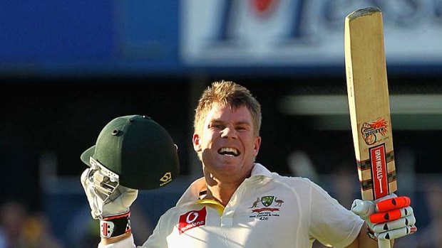Up and away: Australian opener David Warner celebrates his Test century yesterday.