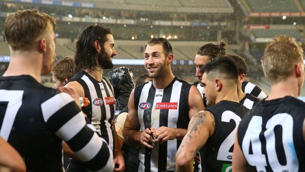 All smiles: Travis Cloke and teammates after the game.