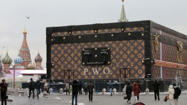 People walk past a Louis Vuitton pavilion which is in the shape of a giant suitcase in central Moscow.