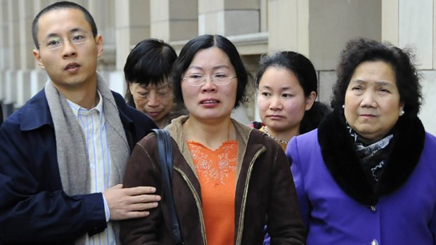Jingfang Zhao [centre] leaves the Supreme Court after her husband's killer was jailed.