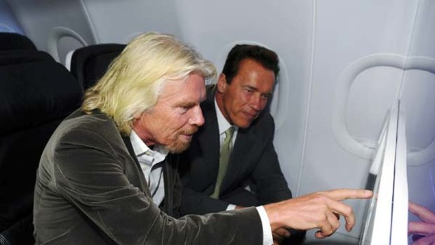 Richard Branson and California Governor Arnold Schwarzenegger on board a Virgin America flight.