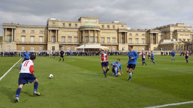 Polytechnic FC (In Blue) play Civil Service FC in a Southern Amateur League football match in the grounds of Buckingham Palace.