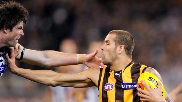 Lance Franklin gives the old "don't argue" to Magpie Leigh Brown at the MCG last night.