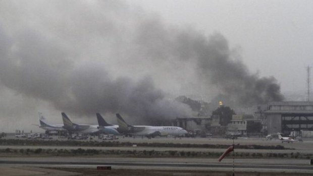 Smoke billows from the airport in Karachi.