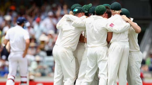 Teammates embrace Ryan Harris after he took the wicket of England's Steven Finn yesterday to wrap up the third Test.