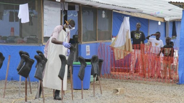 Receiving help: Boys stand in the "red zone" of a treatment centre for Ebola patients in Liberia.