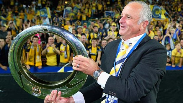 Mariners head coach Graham Arnold with the A-League trophy.