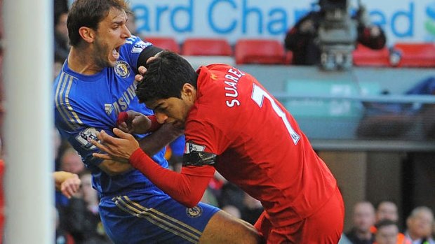 Luis Suarez (R) clashes with Chelsea's Serbian defender Branislav Ivanovic in April.