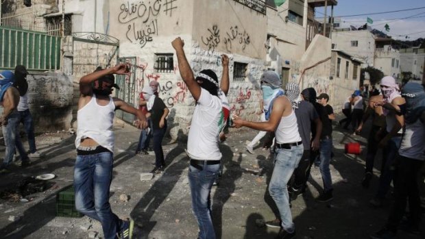 Palestinians hurl stones at Israeli police following the death of Mohammed Sinokrot on Sunday.