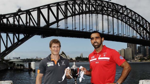 Battleground ... the Giants' Luke Power and Swans' Adam Goodes pose with the Sydney Derby Trophy.