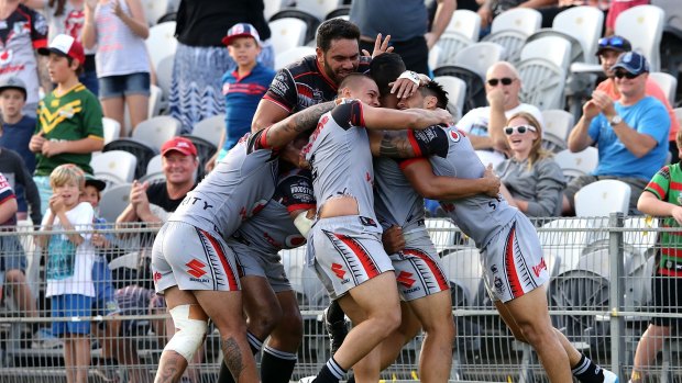 Big win: The Warriors celebrate after snatching the win against the Roosters in golden point.