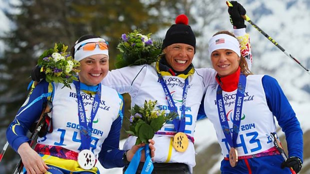 Silver medallist Lyudmyla Pavlenko of Ukraine, gold medallist Andrea Eskau of Germany and bronze medallist Oksana Masters of the United States pose during the medal ceremony for the women's cross-country 5km - sitting on Sunday.