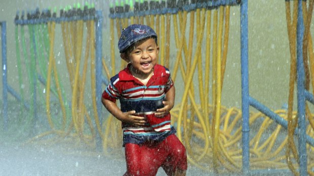 A boy has fun during the opening ceremony of the annual Thingyan water festival celebrations outside Yangon City Hall in Myanmar. 