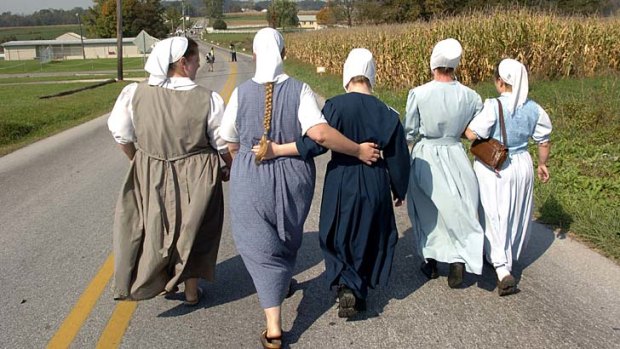 The simple life ... Amish women walk along the quiet road.