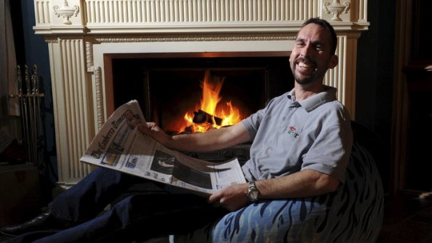 Dominic Stinziani, 44 of Higgins, in front of his open fireplace.