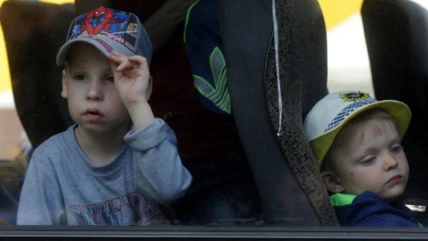 Children in a bus leave the eastern Ukrainian city of Donstsk for their safety and for rest on the Azov sea coast.