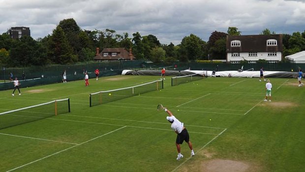 Players practice at the All England Club in Wimbledon, southwest London, on Sunday.