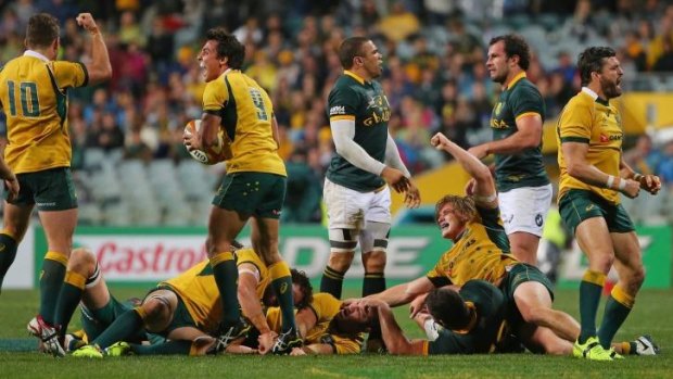 On top: Wallabies celebrate after beating South Africa in Perth on Saturday night.