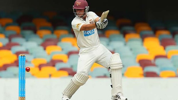 Queensland opener Joe Burns cuts during his knock of 102 on day three of the Sheffield Shield match against Victoria at the Gabba on Tuesday.
