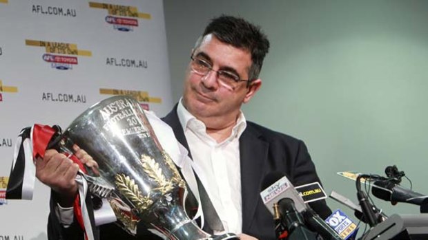 Andrew Demetriou holds the premiership cup at an AFL press conference yesterday.