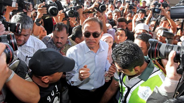 Malaysian Opposition Leader Anwar Ibrahim is mobbed by supporters and the media after his surprise acquittal yesterday on sodomy charges.