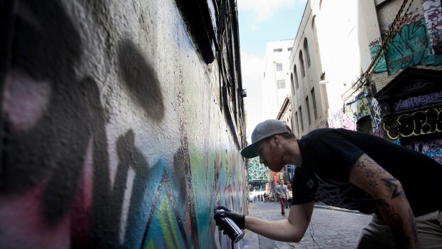 Graffiti artist The Kromster in Hosier Lane