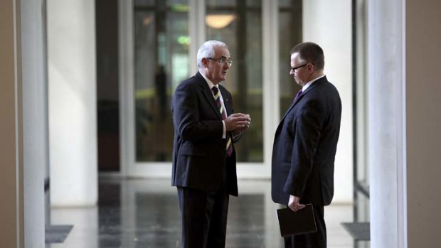 Andrew Wilkie and his chief of staff, Peter Tucker, in strategy mode yesterday ... his $1 bets campaign got short shrift from the Coalition leader's chief of staff.