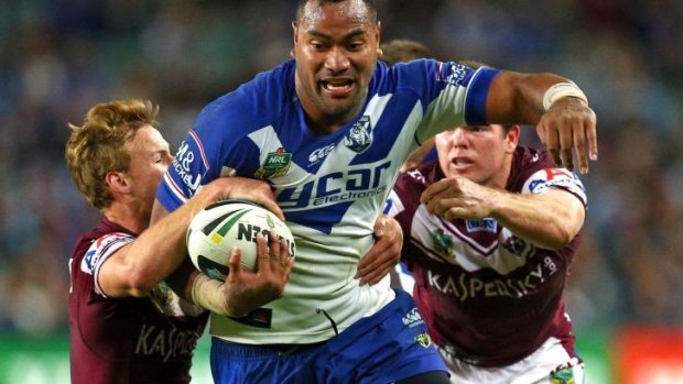 Unleashed: Tony Williams charges through the Manly defence.