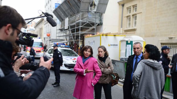 Paris' deputy mayor Anne Hidalgo (centre), speaks with mayor of the 7th arrondissement of Paris, Rachida Dati (right) in front of the nursery school where a man committed suicide.