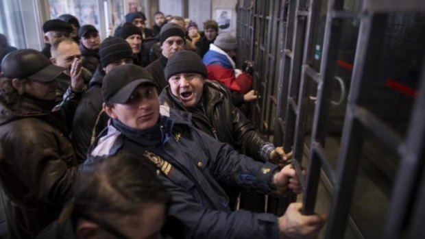 Pro-Russian protesters try to take over the regional parliament building in Donetsk.