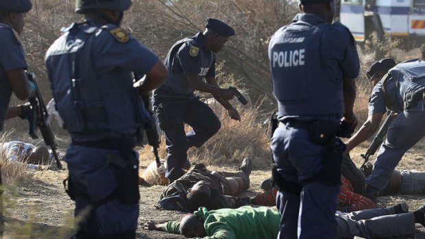 Police surround the bodies of striking miners after the clash at the Lonmin Platinum Mine near Rustenburg, South Africa.