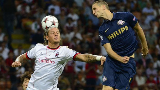 AC Milan's defender Philippe Mexes, left, competes for the ball with PSV 's Adam Maher.