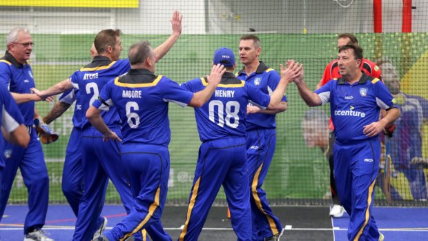 The ACT under-40s team celebrate a wicket at the Australian Masters Championships.