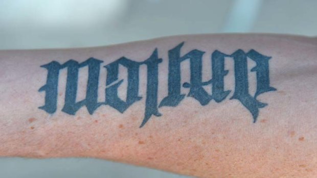 Tatt's clever: a tattoo on Carlisle's left arm can be read as "mother" one way.