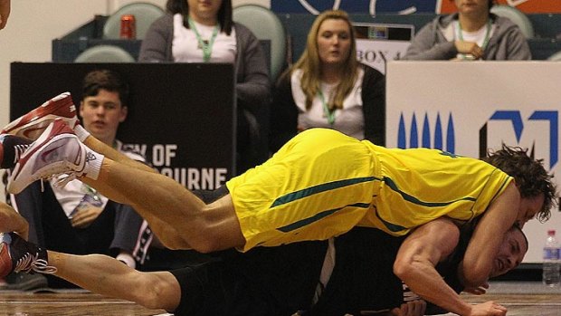 Australia's Matthew Nielsen clashes with Tall Black Mark Dickel at State Netball Hockey Centre in Melbourne last night.