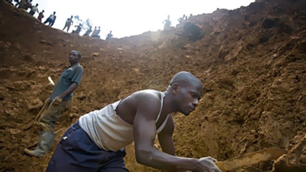 Men mine for tin ore in a pit in Bisie, Congo that was part of a lucrative operation controlled by renegade soldiers in August 2008.