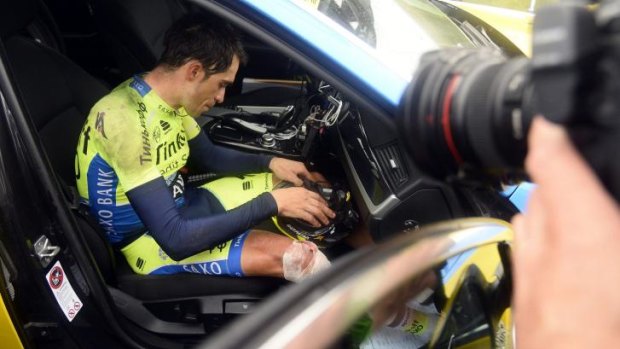 Alberto Contador breaks dow in the Tinkoff-Saxo team car after he crashed on Monday's 10th stage.