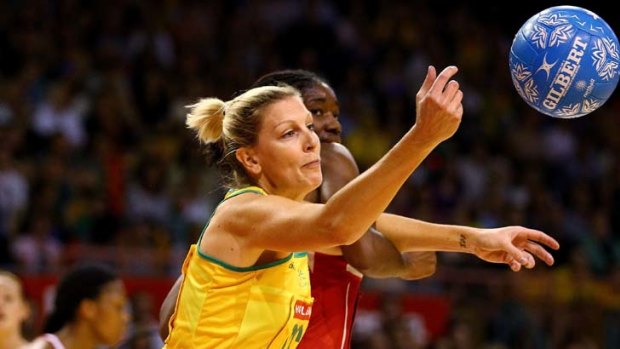 Contested ... Australia's Catherine Cox and England's Eboni Beckford-Chambers engage in a battle for the ball during the Diamonds' 62-47 win.