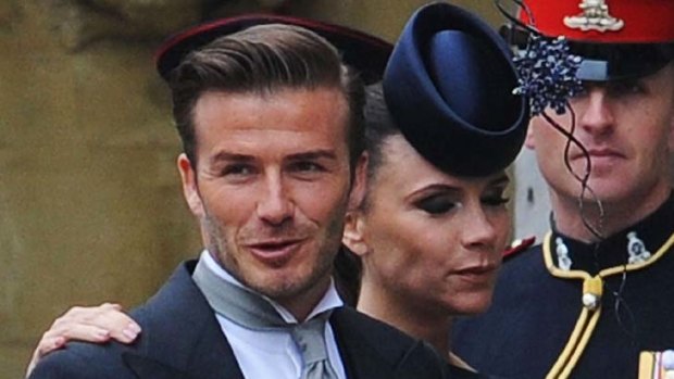 A posh day out ... Victoria and David Beckham await the start of the ceremony.