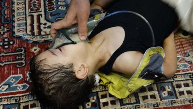 A boy breathes through an oxygen mask in the Damascus suburb of Saqba after an attack the US now says involved the nerve agent sarin.