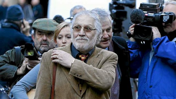 British radio jockey Dave Lee Travis, centre, arrives for the start of his trial in London.